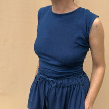 Load image into Gallery viewer, Person wearing a blue outfit against a beige background