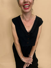 Load image into Gallery viewer, Woman wearing a black top and wide leg trousers with a beige background