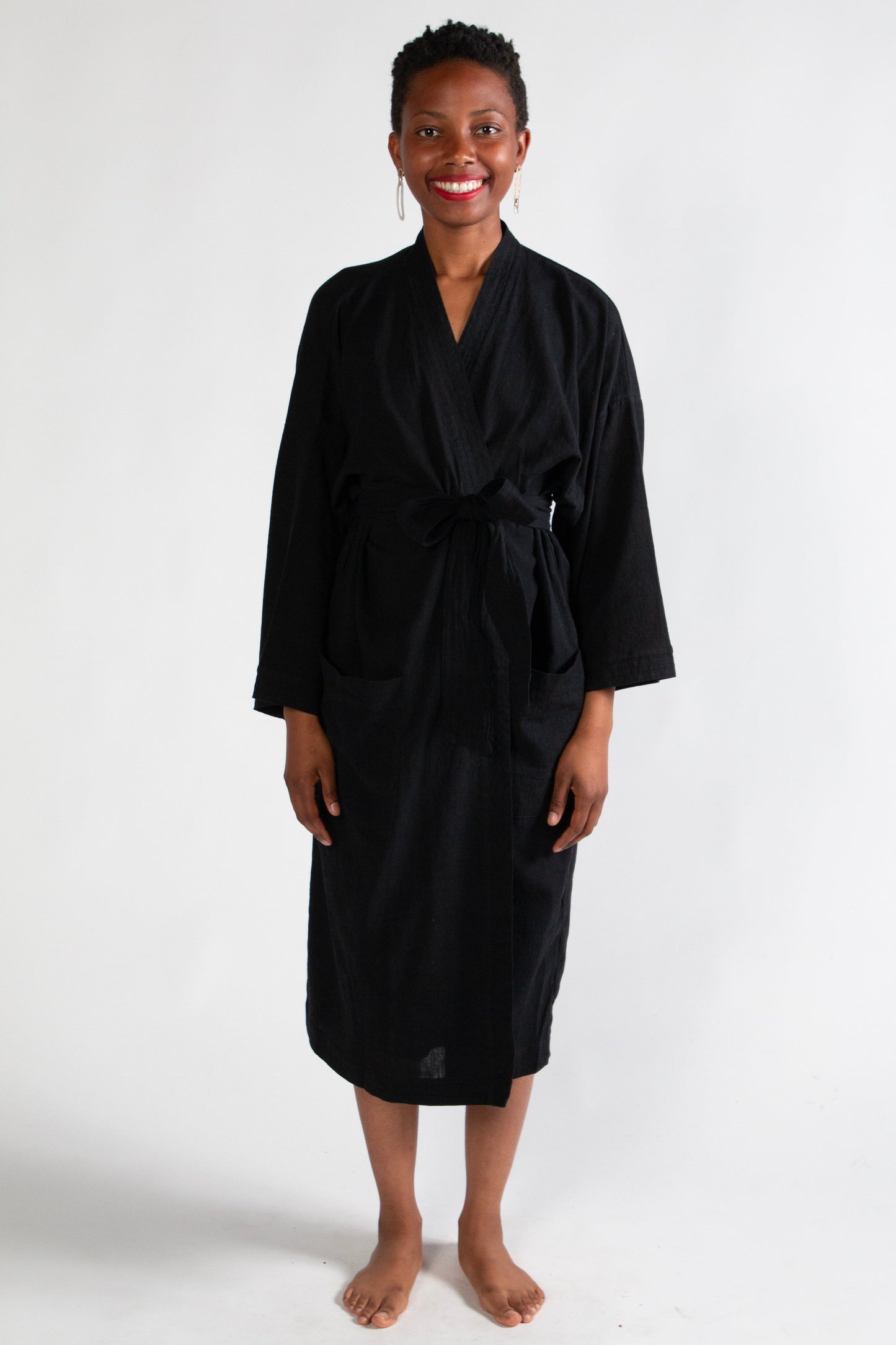 Woman wearing a black robe on a white background