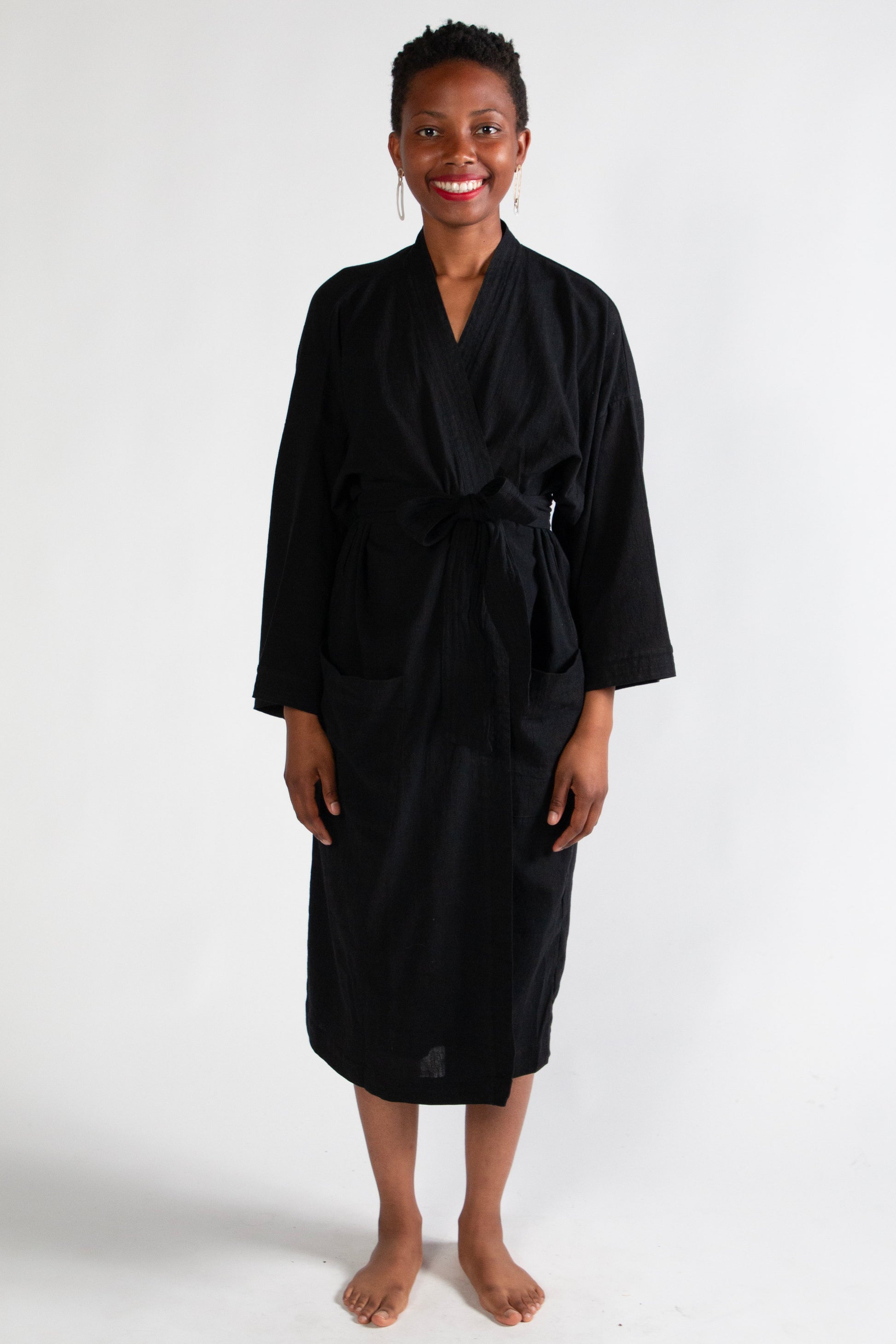 Woman wearing a black robe on a white background