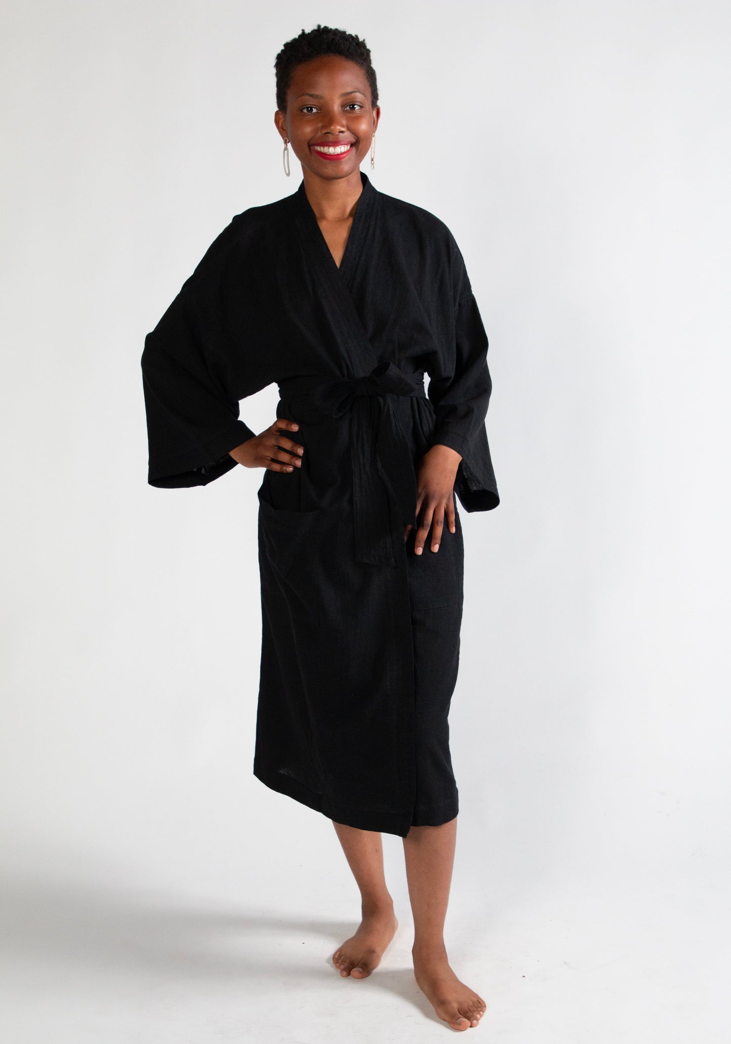 Woman wearing a black robe on a white background