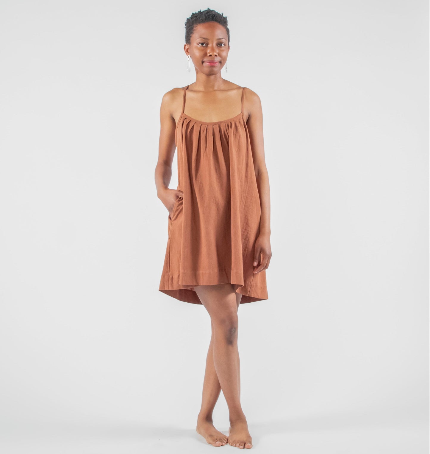 Woman wearing a brown dress on a white background