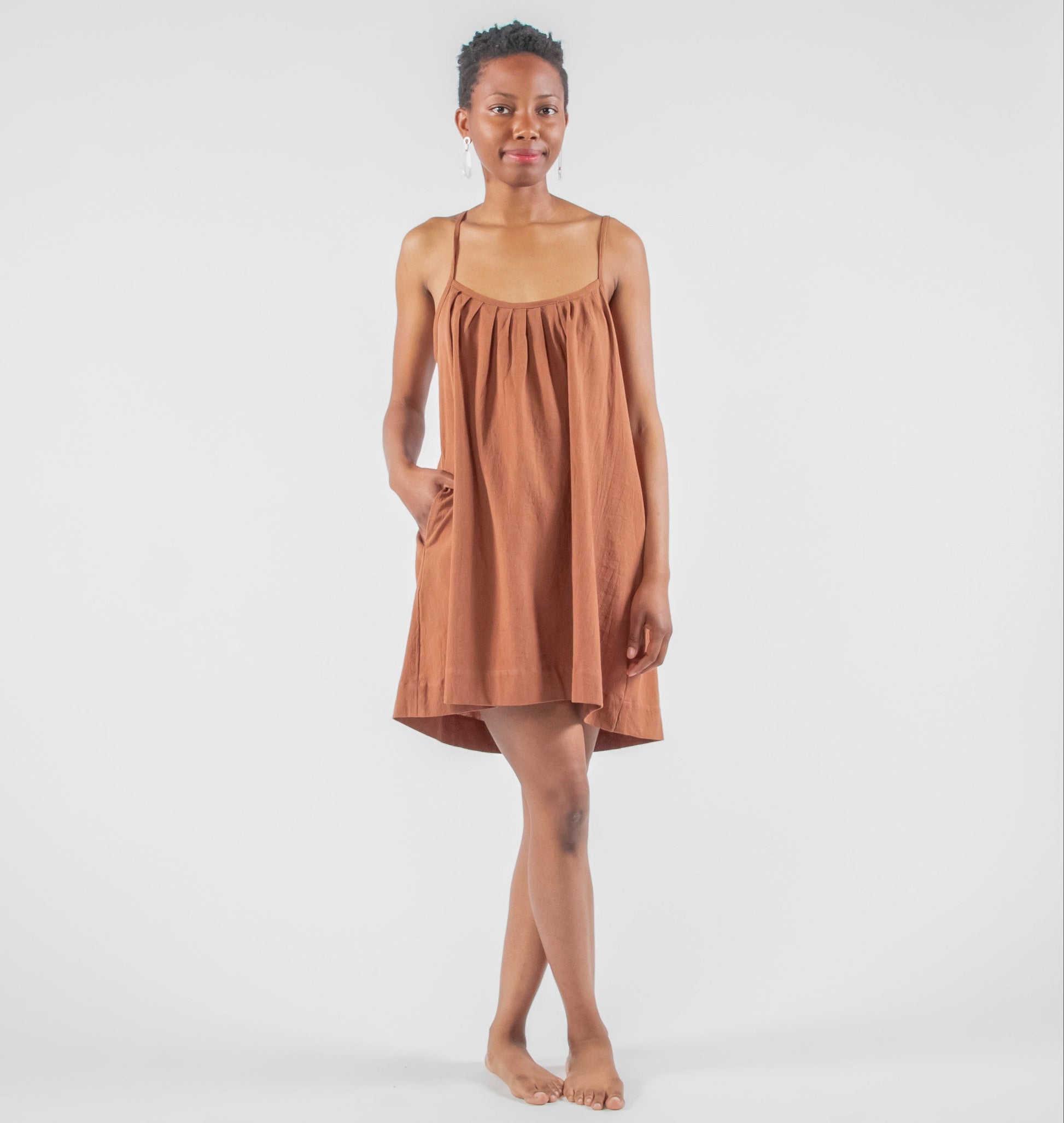 Woman wearing a brown dress on a white background