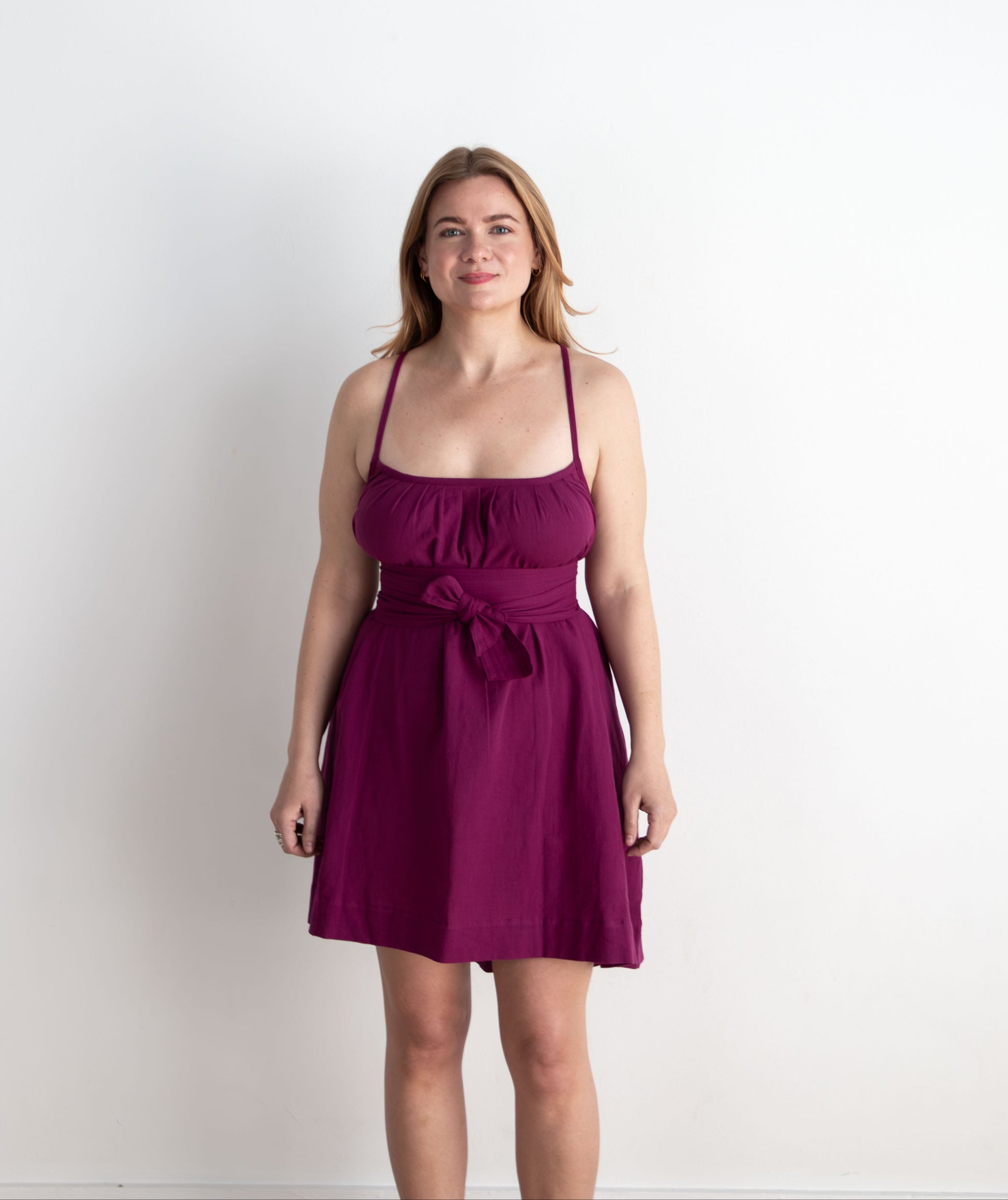 Woman wearing a purple dress against a white background