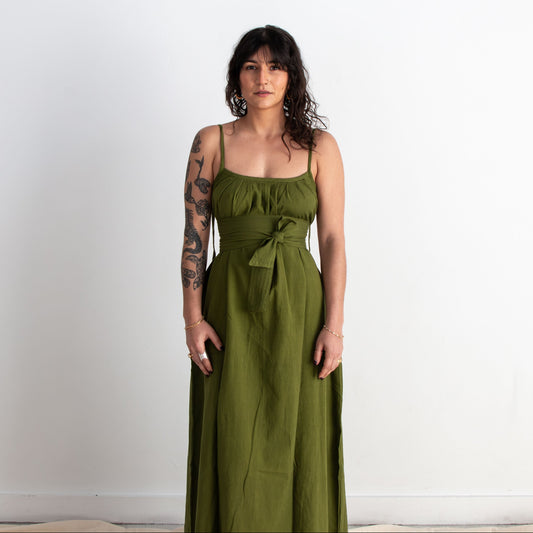 Woman wearing a green dress against a white background