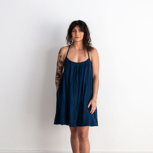 Woman wearing a navy blue dress against a white background