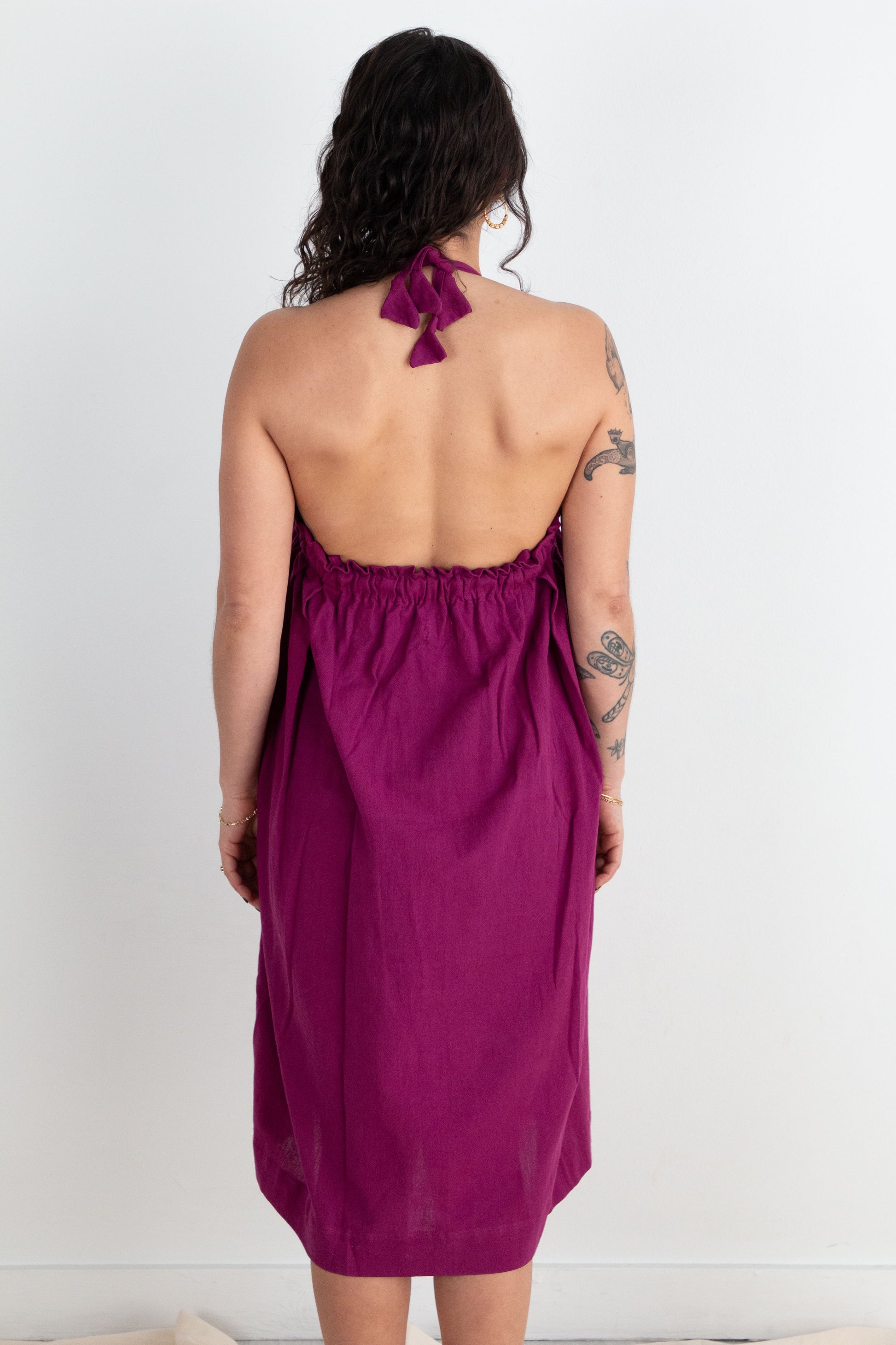 Woman wearing a purple dress with a white background