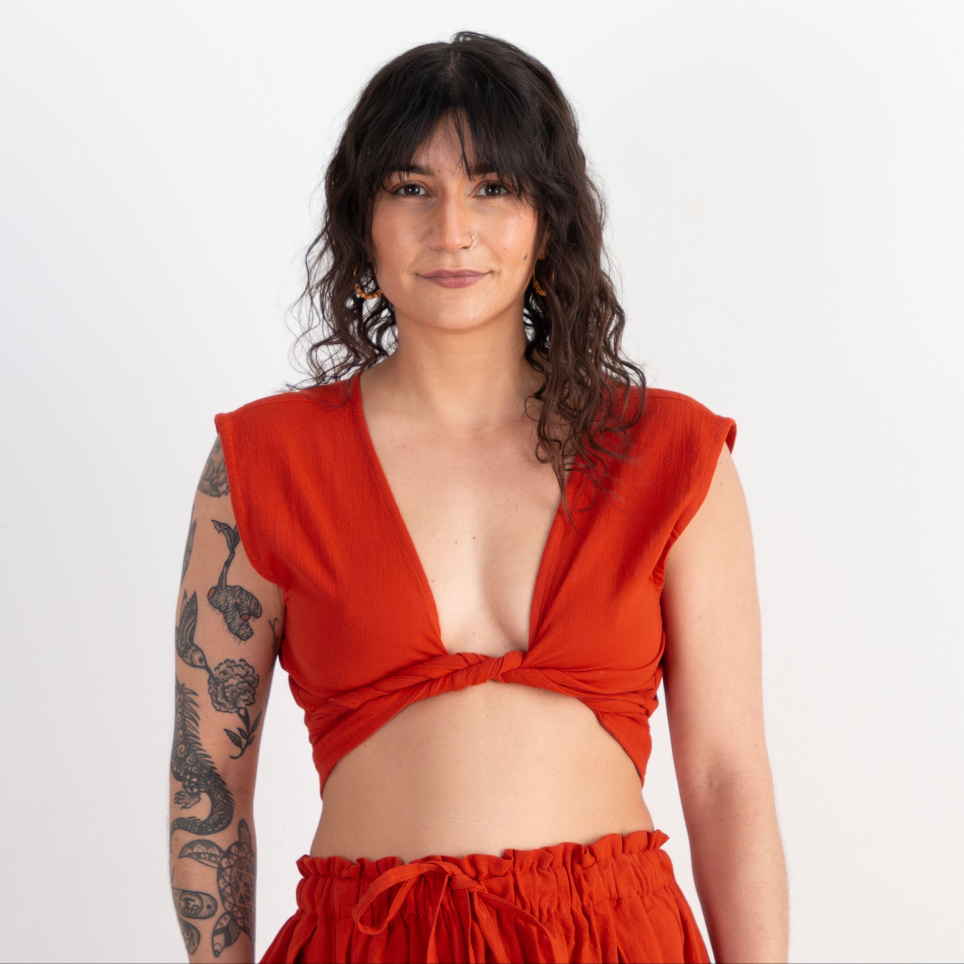 Woman wearing a red outfit with a plain background