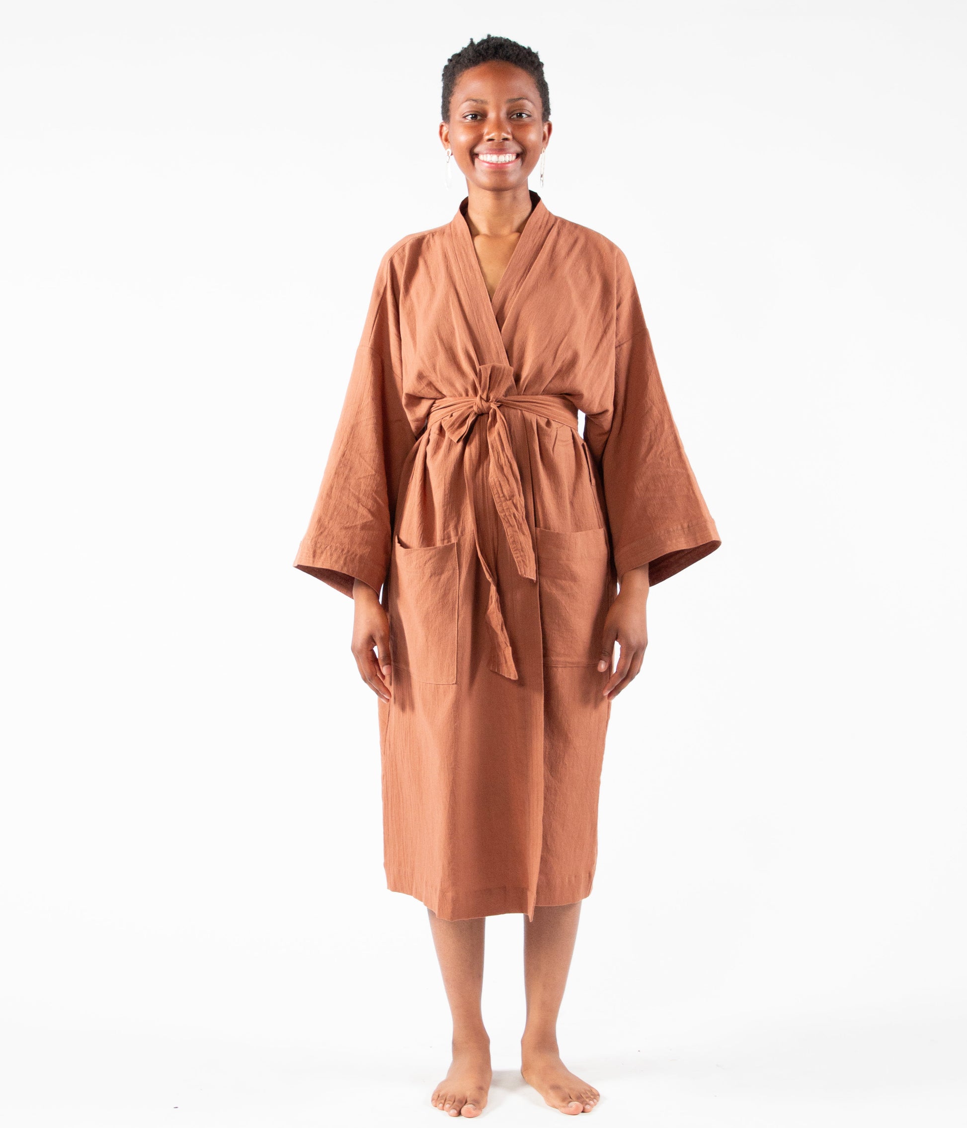Woman wearing a brown robe on a white background