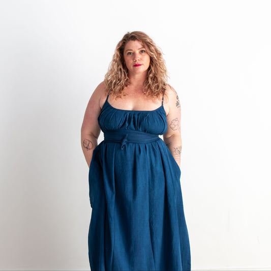 Woman wearing a blue dress against a white background