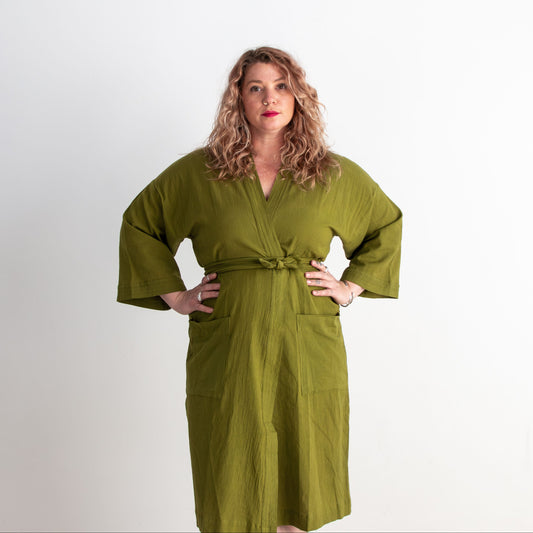 Woman wearing a green robe against a white background